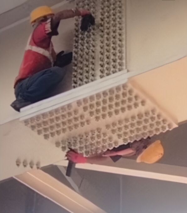 Bonding agent applied across a dense array of HSFG bolt heads on a girder