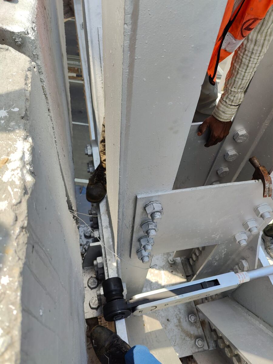 Torque wrench applied to HSFG bolts on a girder splice plate