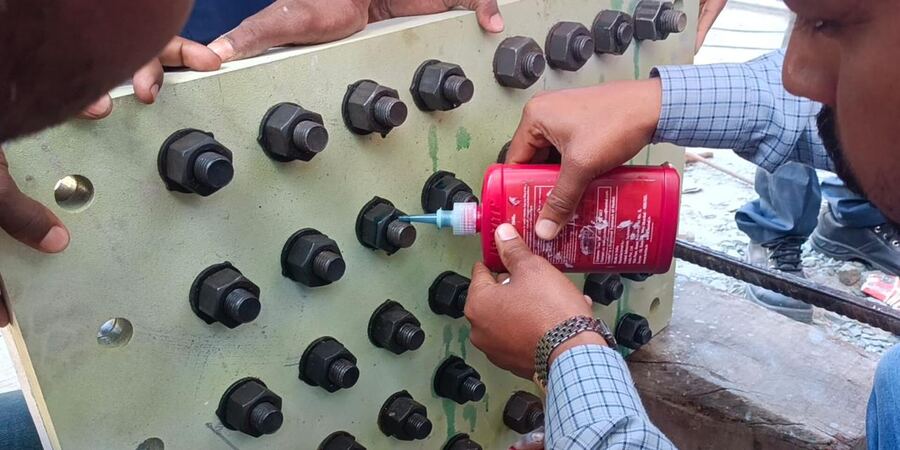 Threadlocker applied from the bottle onto HSFG bolts on a splice plate